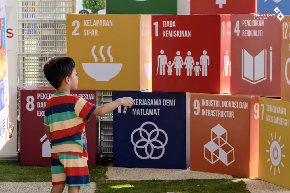 A young visitor explores the Sustainable Development Goals display at the launch of the Targeted SDG Bersasar Programme 2026 in Batu Pahat.